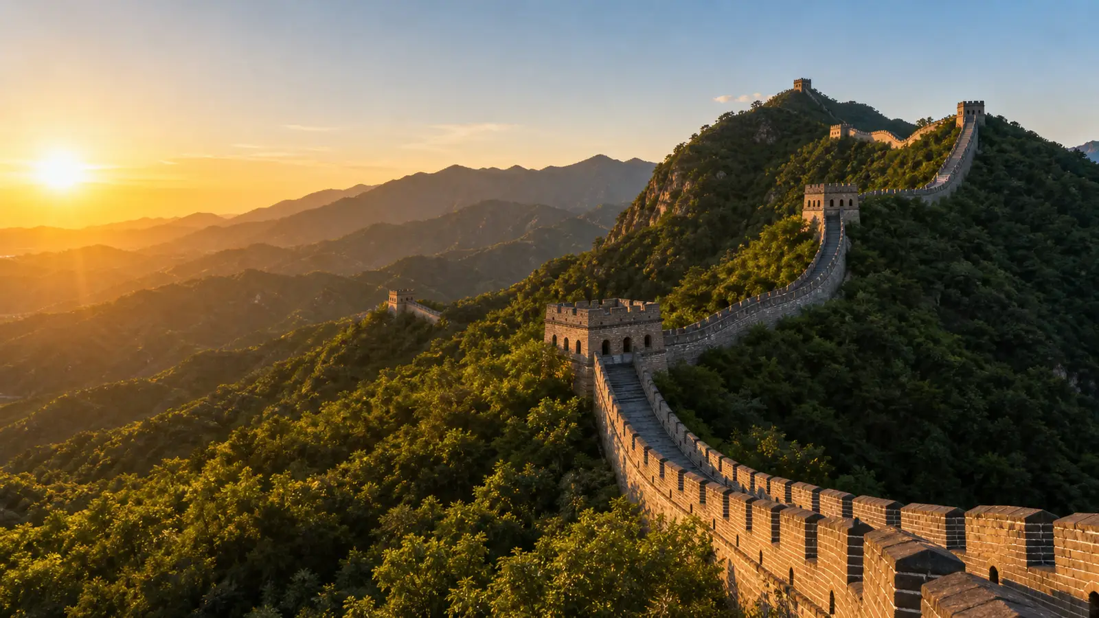 The Great Wall of China snaking along a forested ridgeline at Mutianyu in early light